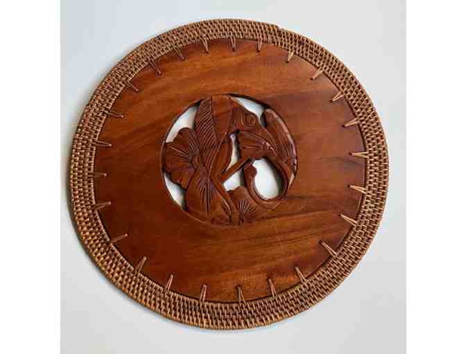 Two plaques with images of birds, carved of teakwood with rattan border